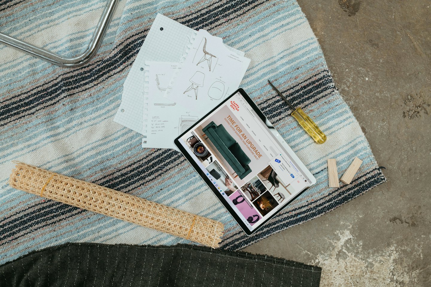 Tablet with furniture website, sketches, and tools for renovation.